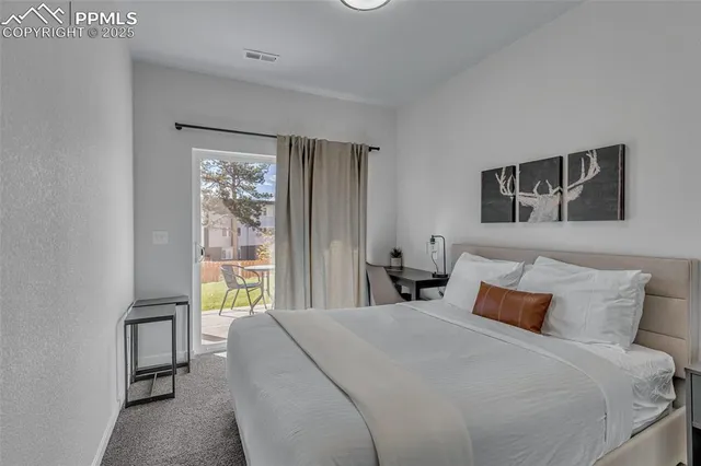 a bedroom with bed and window