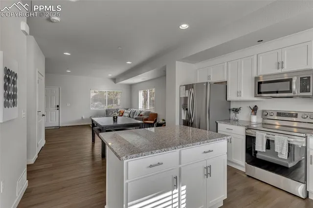 a kitchen with stainless steel appliances granite countertop a stove and a sink