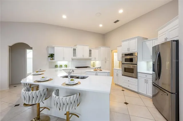 a living room with furniture and kitchen view