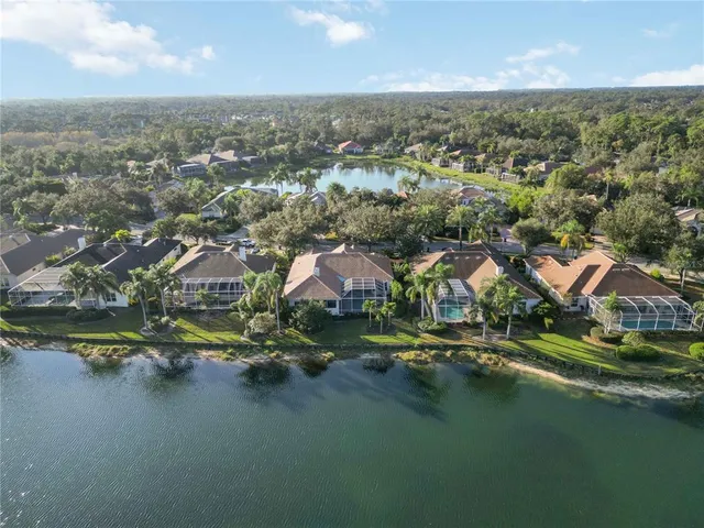a room with lots of tables a large window and chairs