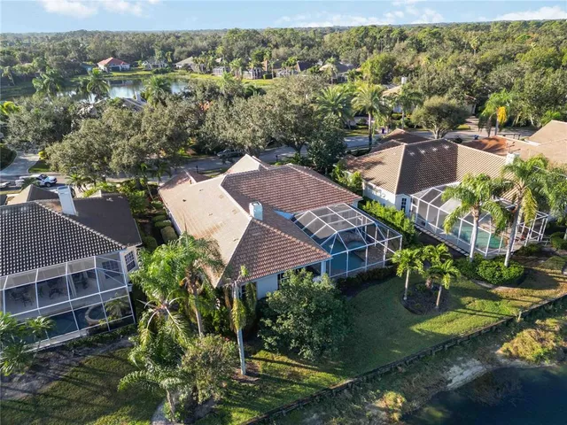 a view of a dining room with furniture large windows and garden view