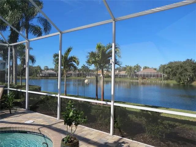a view of a dining room with furniture and a chandelier