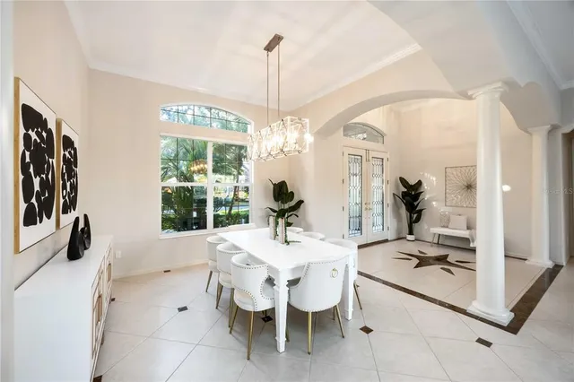 a dining room with furniture a chandelier and wooden floor