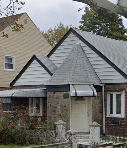 a view of a white house with large windows