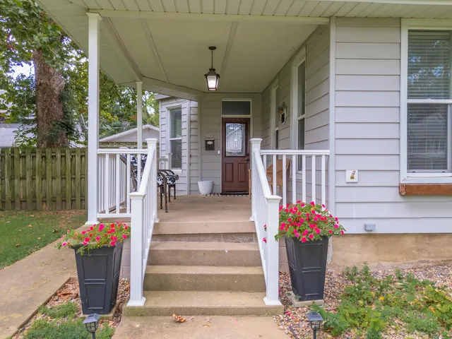 a front view of a house with a fountain