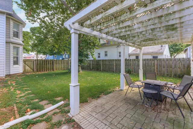 a backyard of a house with outdoor seating