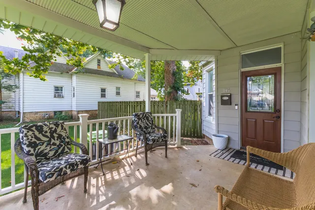 a balcony with furniture and potted plants