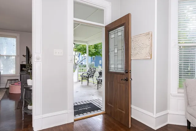 a view of hallway with wooden floor and furniture