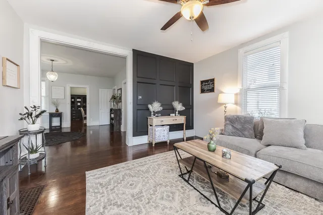 a living room with furniture and a wooden floor