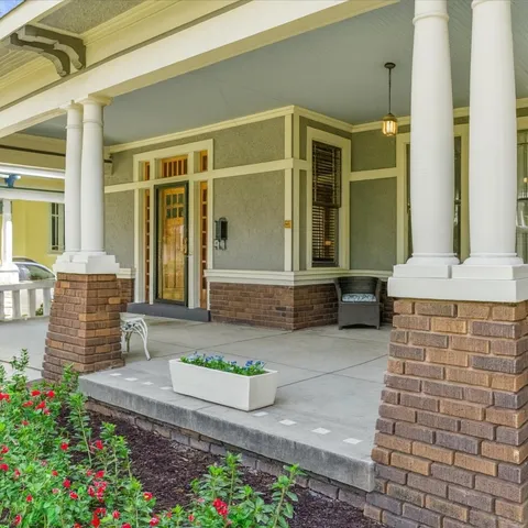 a front view of a house with a garden