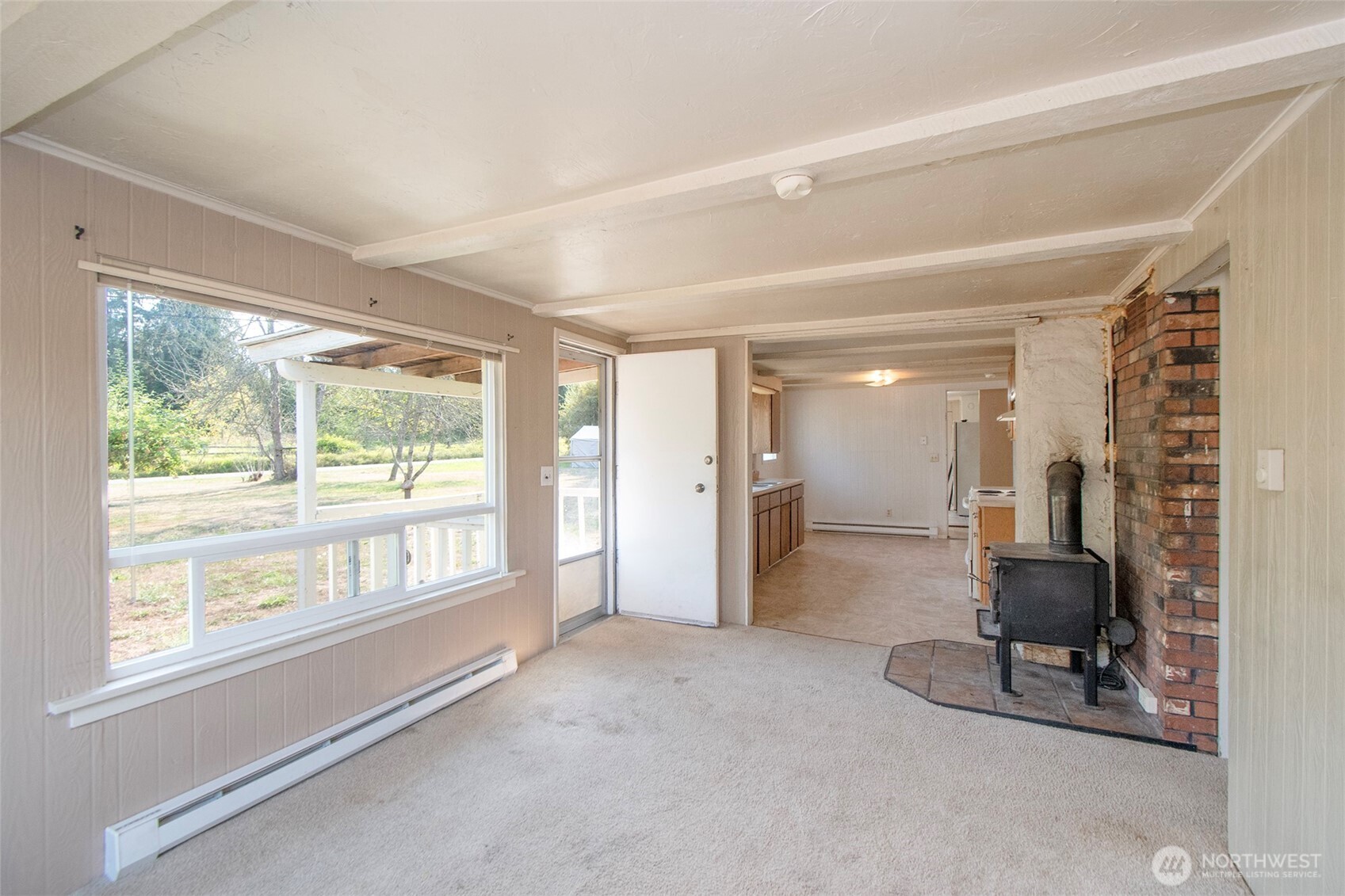 190 Pierson Road Sequim, WA 98382 - Photo 9 of 40 a view of an empty room with a fireplace and a large window
