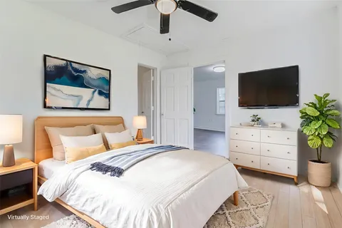 a bedroom with a bed and a flat screen tv