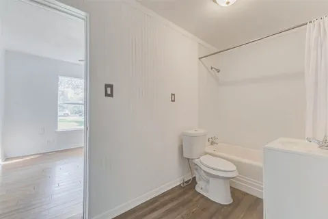 a view of room with wooden floor and closet