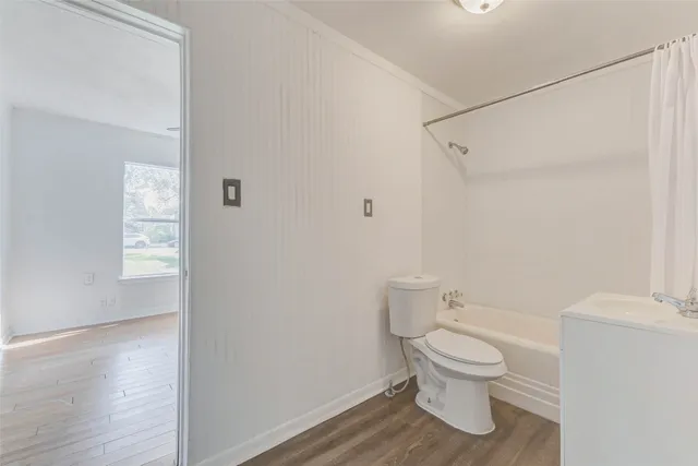 a view of room with wooden floor and closet
