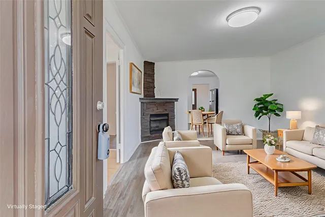 a living room with furniture and a fireplace