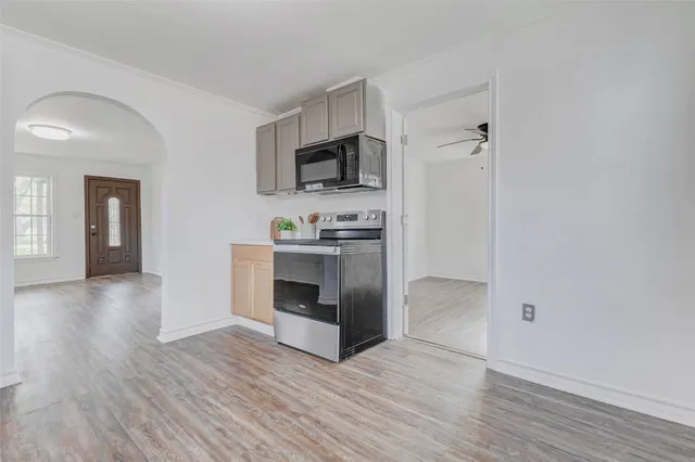 a view of kitchen with microwave and cabinets