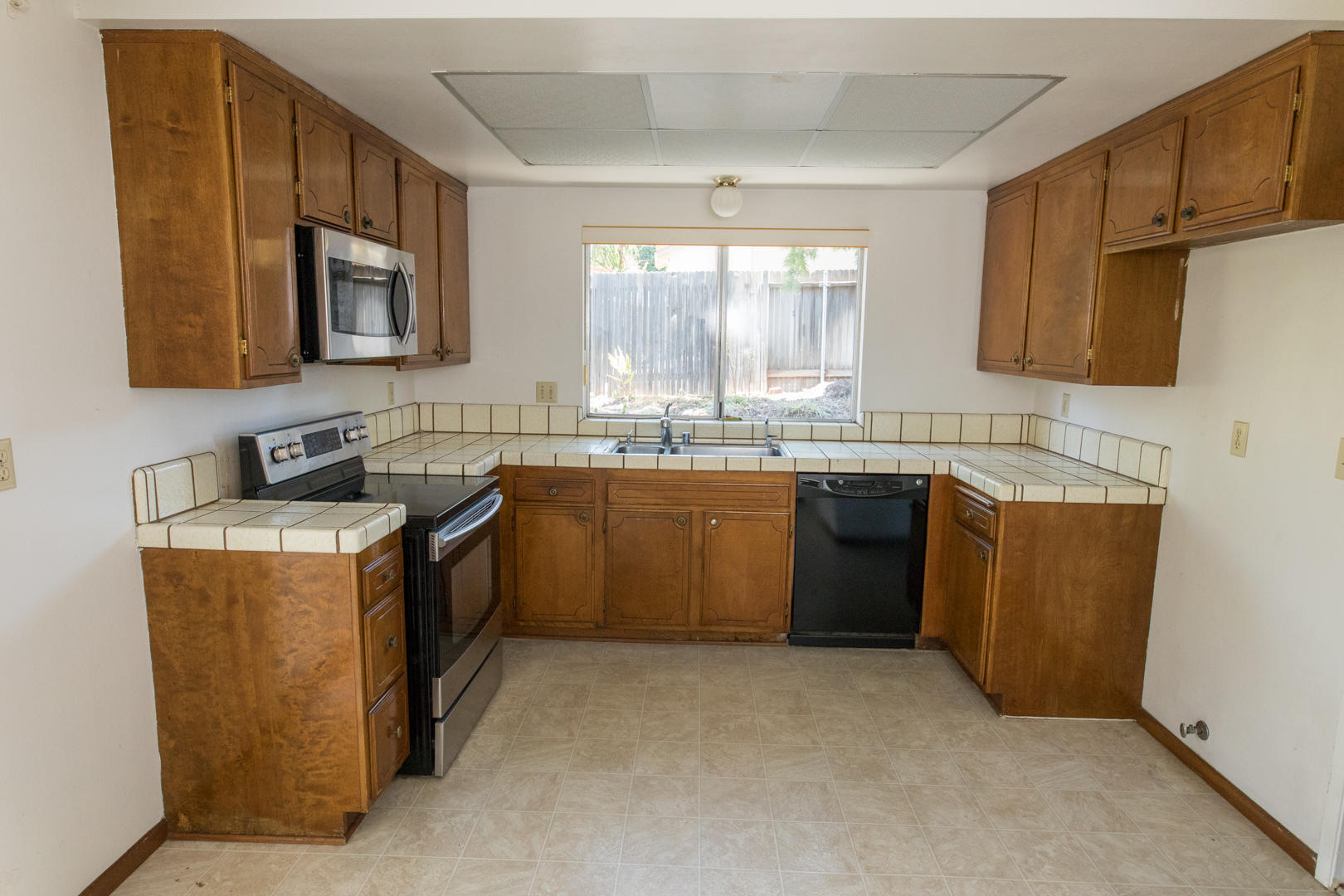614 Arundel Road Goleta, CA 93117 - Photo 4 of 18 a kitchen with a sink stove and microwave