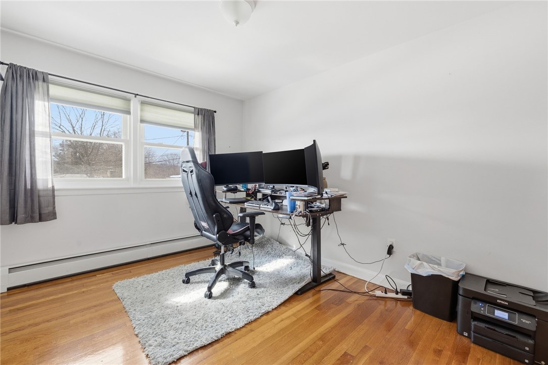 15 Anita Road Johnston, RI 02919 - Photo 13 of 28 The first of three bedrooms features double windows (replacement) and hardwood flooring.