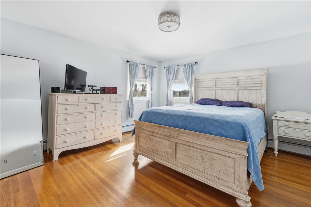 15 Anita Road Johnston, RI 02919 - Photo 16 of 28 Natural light pours into the primary bedroom. This spacious room is able to accommodate multiple pieces of larger furniture.
