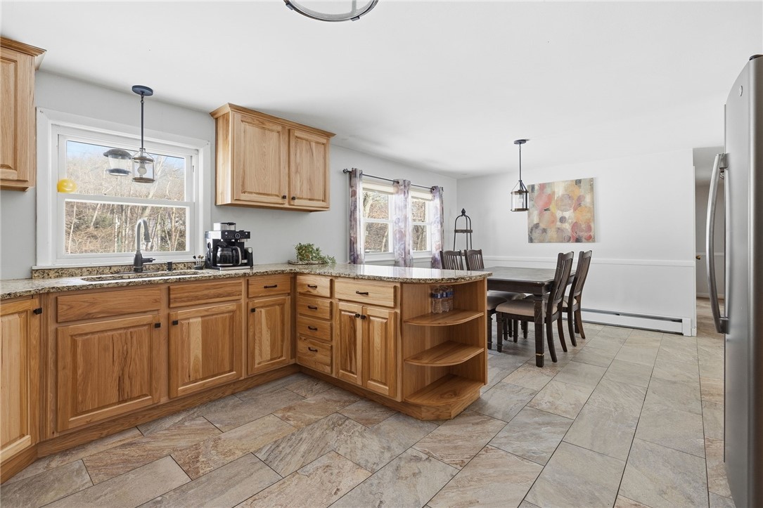 15 Anita Road Johnston, RI 02919 - Photo 7 of 28 Hickory cabinets and a neutral color palette.
