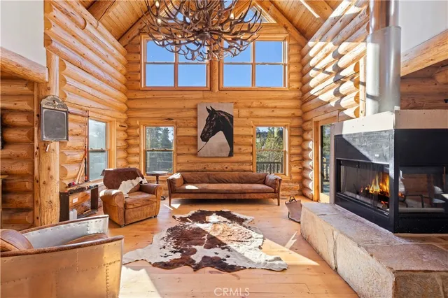a dining room with furniture a wooden floor and kitchen view
