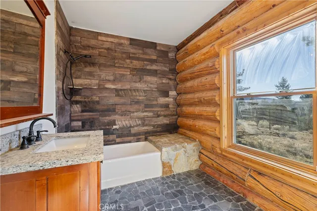 a spacious bedroom with a bed and a large window