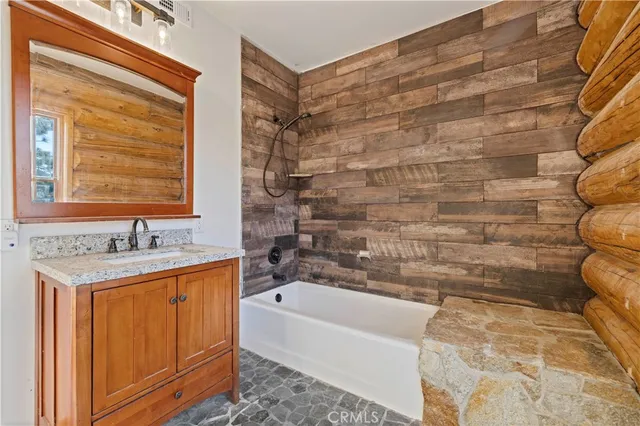 a spacious bathroom with a tub a double vanity sink a mirror and a shower