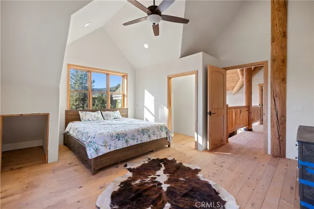 a front view of a house with yard and trees