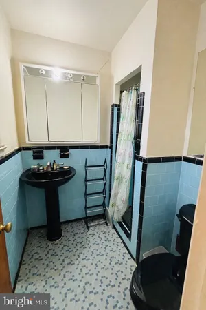 a bathroom with a sink a toilet and a mirror