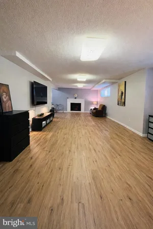 a view of a livingroom with furniture a flat screen tv and staircase