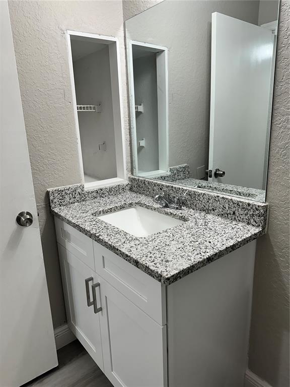 1025 South Hiawassee Road, Unit 2214 Orlando, FL 32835 - Photo 11 of 26 a bathroom with a granite countertop sink and a mirror