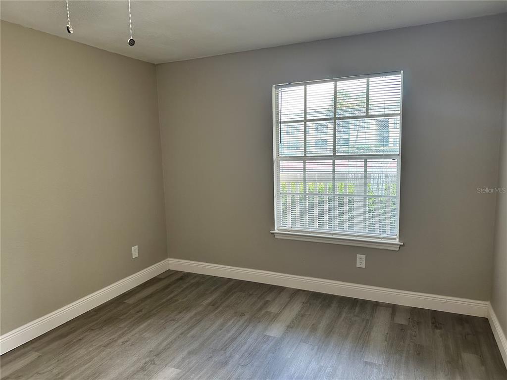 1025 South Hiawassee Road, Unit 2214 Orlando, FL 32835 - Photo 14 of 26 an empty room with wooden floor and windows