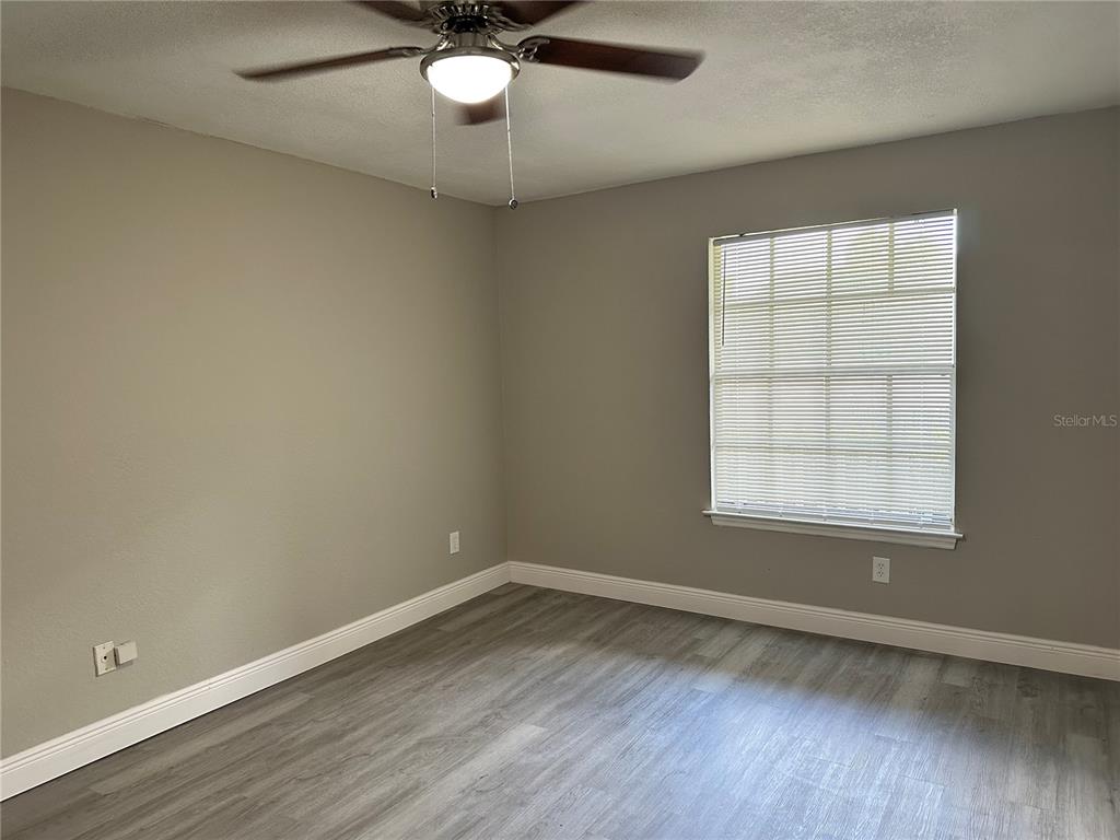 1025 South Hiawassee Road, Unit 2214 Orlando, FL 32835 - Photo 16 of 26 an empty room with wooden floor and windows