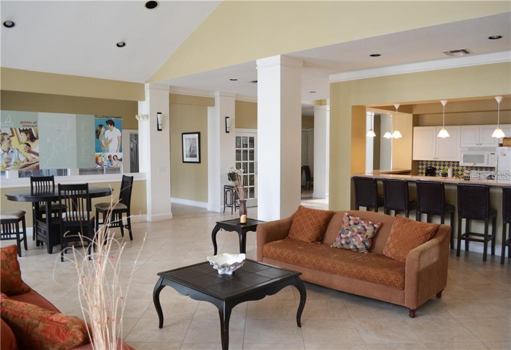 1025 South Hiawassee Road, Unit 2214 Orlando, FL 32835 - Photo 19 of 26 a living room with furniture kitchen view and a wooden floor