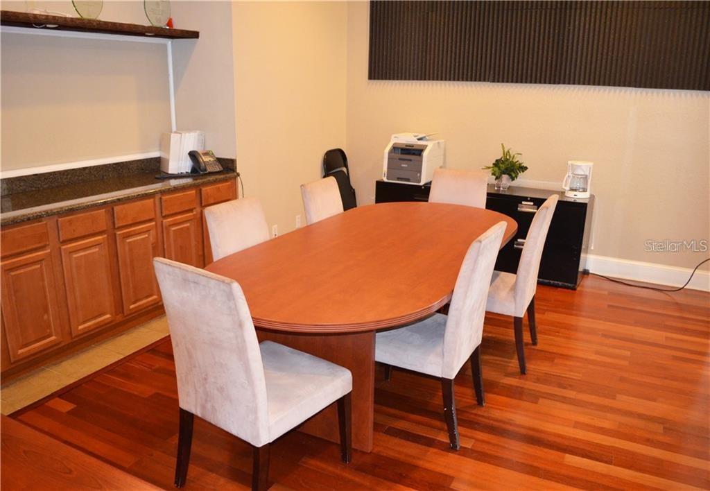1025 South Hiawassee Road, Unit 2214 Orlando, FL 32835 - Photo 20 of 26 a view of a dining room with furniture and wooden floor