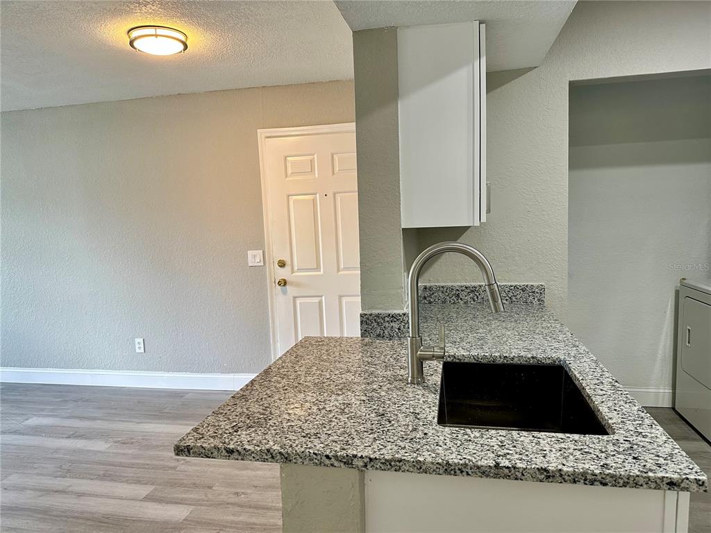 1025 South Hiawassee Road, Unit 2214 Orlando, FL 32835 - Photo 8 of 26 a kitchen with granite countertop a coffee maker and granite countertops