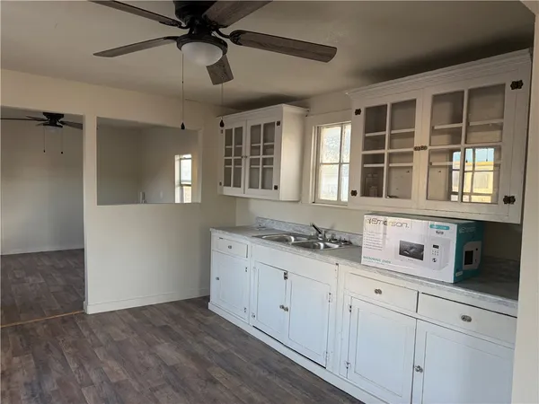 a kitchen with granite countertop a sink and cabinets