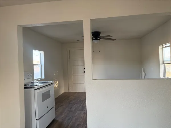 a view of kitchen with cabinets and window