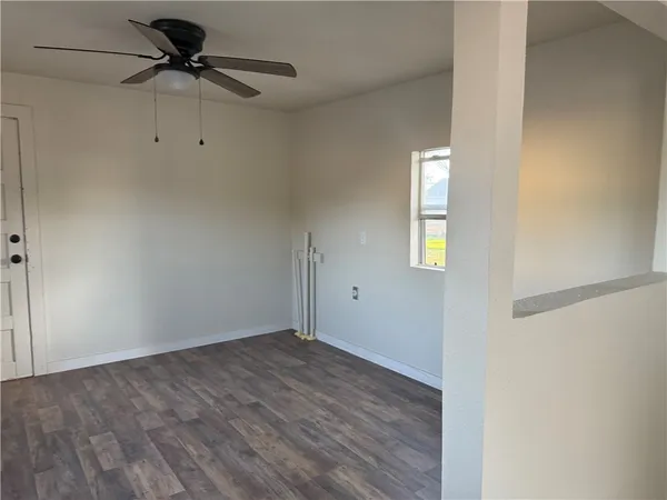 wooden floor in an empty room with a window