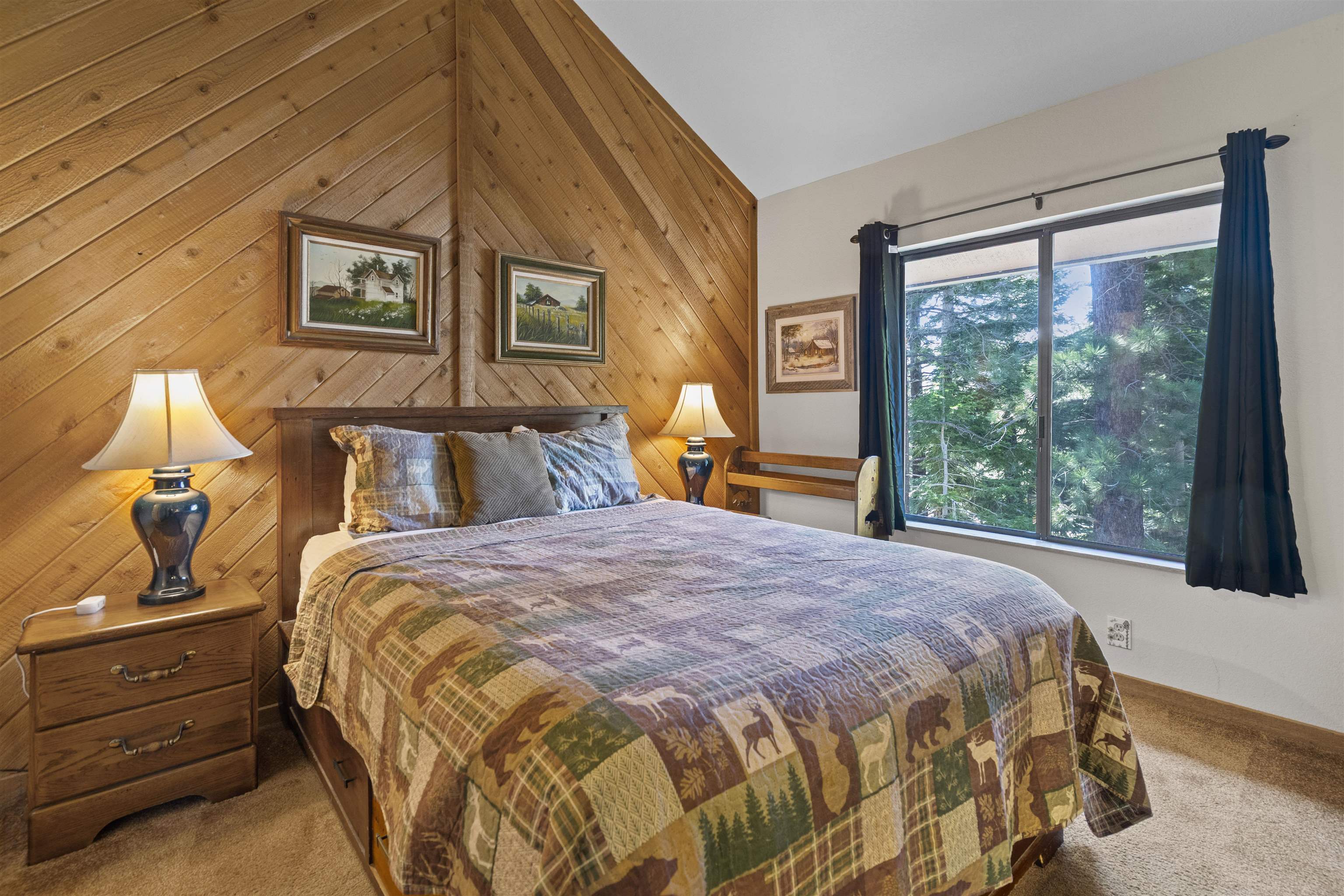 153 Lake Mary Road, Unit 114 Mammoth Lakes, CA 93546 - Photo 7 of 22 Bedroom featuring a wood-paneled accent wall, vaulted ceiling, built-in wooden headboard, and a large window