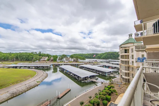 a view of a city from a balcony with furniture