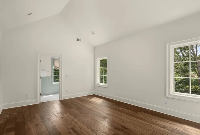 a living room with furniture and a painting on the wall