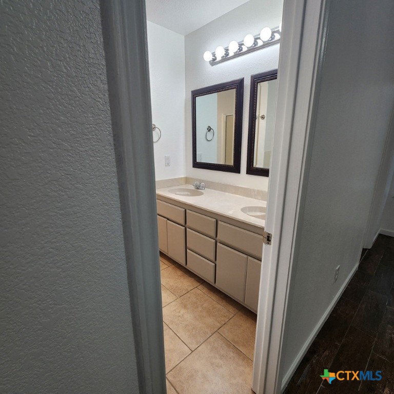 1111 Travis Circle Copperas Cove, TX 76522 - Photo 12 of 24 a bathroom with a double vanity sink and a mirror