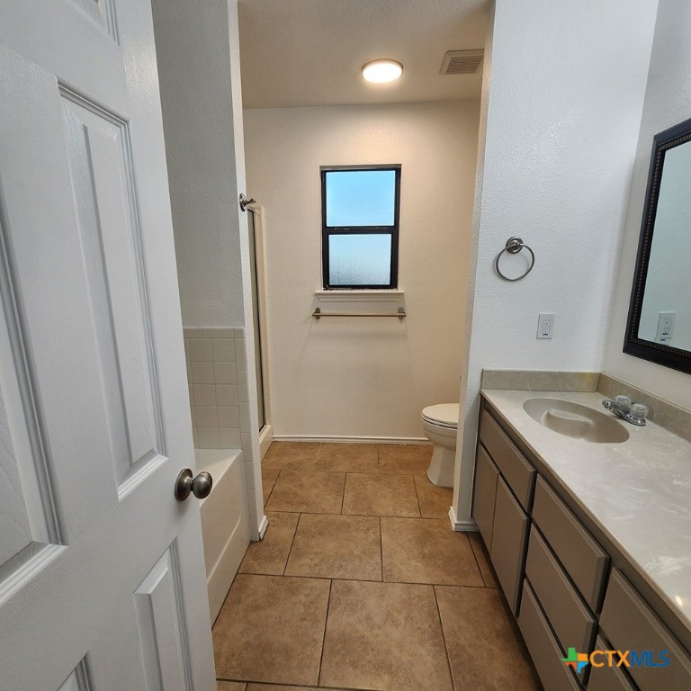 1111 Travis Circle Copperas Cove, TX 76522 - Photo 14 of 24 a bathroom with a sink a toilet and a mirror
