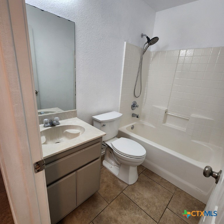1111 Travis Circle Copperas Cove, TX 76522 - Photo 17 of 24 a bathroom with a granite countertop toilet a sink and a bathtub