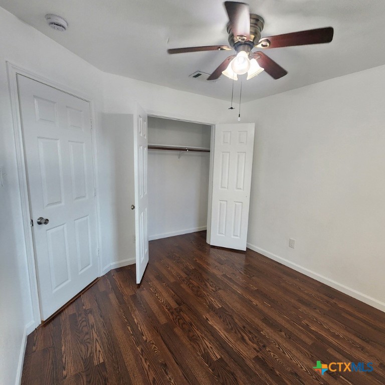 1111 Travis Circle Copperas Cove, TX 76522 - Photo 18 of 24 a view of an empty room with a ceiling fan a ceiling fan and wooden floor