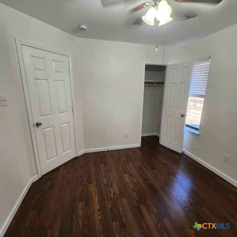 1111 Travis Circle Copperas Cove, TX 76522 - Photo 22 of 24 an empty room with wooden floor and windows