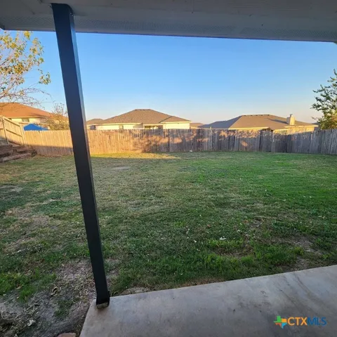 a view of a big yard next to a house