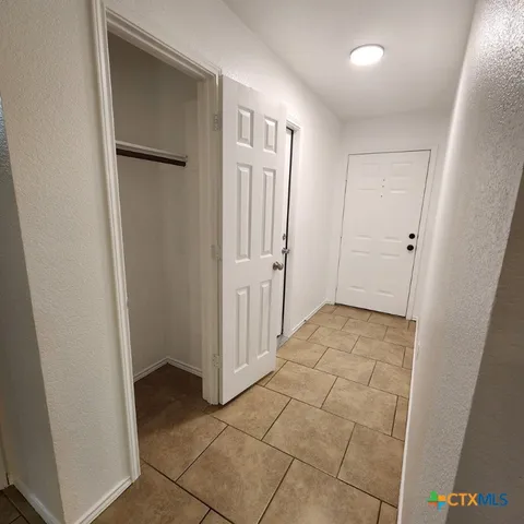 a view of a hallway with closet area