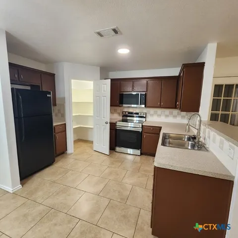 a kitchen with a sink a cabinets and window